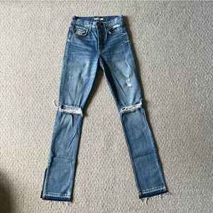 High waist light wash denim with button fly and split at hem